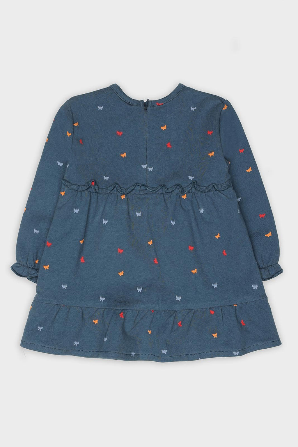 Vista lateral do vestido infantil Street Monkey, evidenciando as mangas compridas com punhos elásticos e o corte solto em flanela.