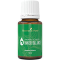Frasco de óleo essencial Animal Scents Inner Balance da Young Living sobre fundo neutro.